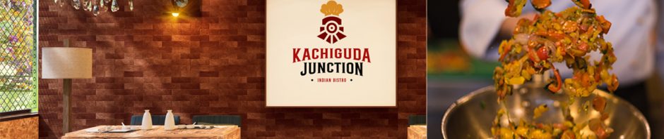 A split-image showcases an Indian restaurant and a live cooking scene. On the left, the interior of "Kachiguda Junction Indian Bistro" features wooden tables with navy blue chairs, neatly set with white tableware. A large sign with the restaurant's name and a chef's hat logo is mounted on a textured red brick wall, illuminated by warm lighting and a chandelier. On the right, a chef in a white uniform skillfully tosses a mix of colorful vegetables, including red and yellow bell peppers, carrots, and herbs, in a sizzling wok over an open blue flame, emphasizing freshness and culinary expertise.